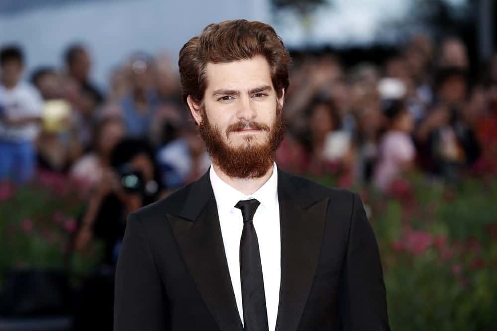 Andrew Garfield paired his mussed up hairstyle with a bearded look when he attended the "99 Homes" premiere during the 71st Venice Film Festival on August 29, 2014 in Venice, Italy.