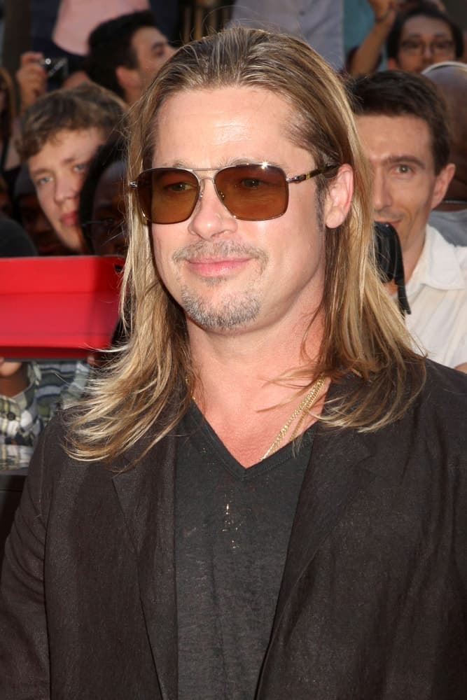Brad Pitt attended the premiere of "World War Z" in Times Square on June 17, 2013 in New York City. He wore a casual outfit to go with his long highlighted hairstyle and sexy sunglasses.