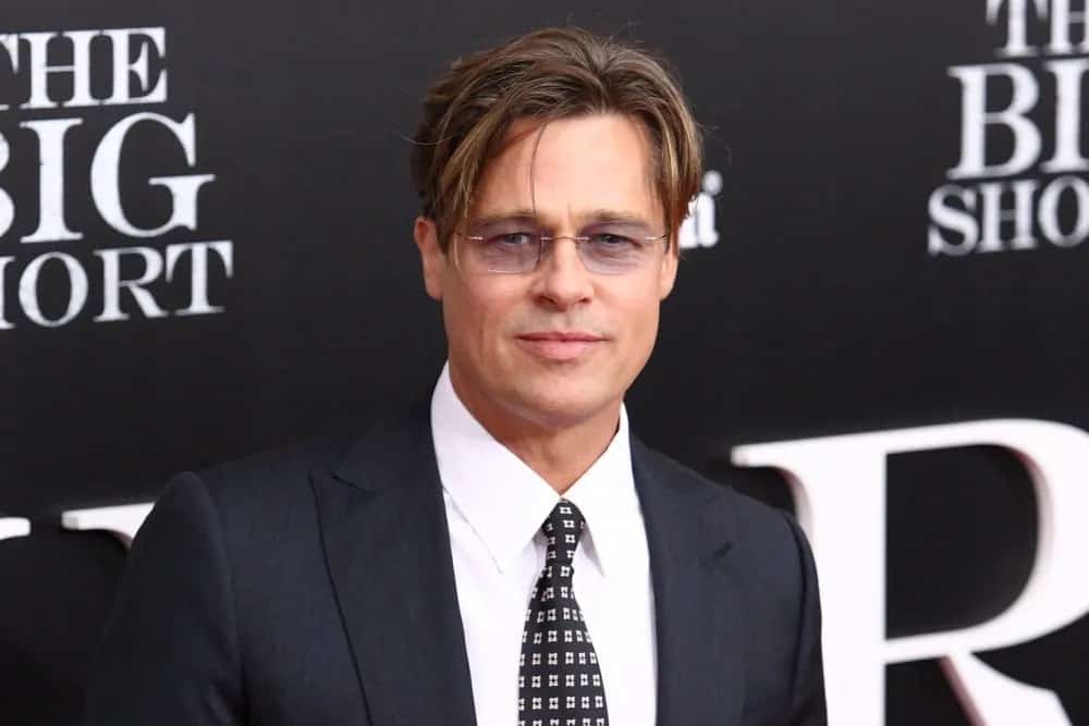 The iconic actor Brad Pitt showed up with a tousled and side-parted casual hairstyle during the premiere of his film "The Big Short" at the Ziegfeld Theatre back in November 23, 2015 in New York City.