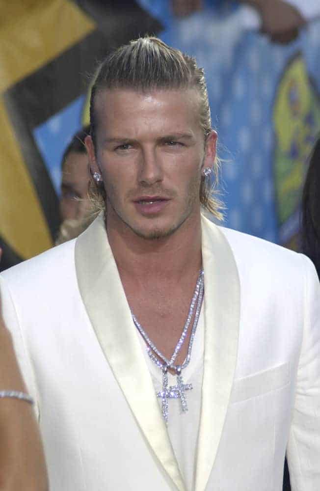 David Beckham looked fashionable with a top knot and white suit during the 2003 MTV Movie Awards on May 31st in Los Angeles. HE finished the look with sparkling blings and earrings.