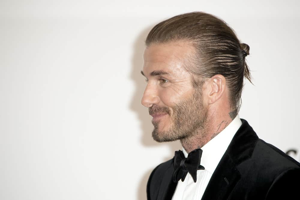 David Beckham shows the side profile of his man bun during the amfAR Gala Cannes 2017 at Hotel du Cap-Eden-Roc on May 25, 2017 in Cap d'Antibes, France.