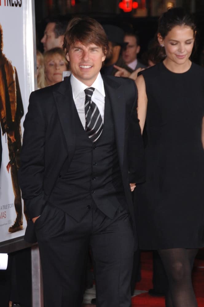 Tom Cruise and his wife were at the world premiere of "The Pursuit of Happiness" at the Mann Village Theatre, Westwood back in December 7, 2006. Cruise wore a three-piece suit to go with his long and tousled hair with bangs.