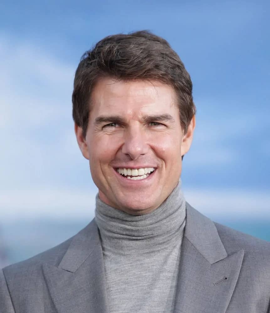 Tom Cruise flashed his signature smile at the "Oblivion" US Premiere on April 10, 2013 in Hollywood, CA with a jagged short hairstyle to match his turtle neck outfit.