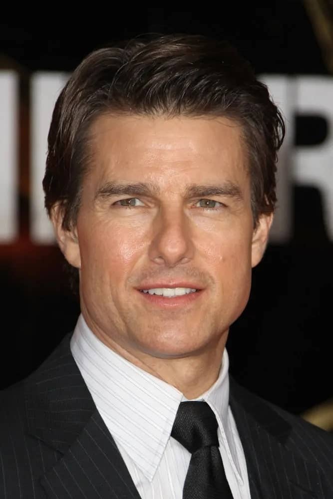 Tom Cruise was at the premiere of "Edge Of Tomorrow" held at the BFI IMAX back in May 28, 2014 in London, United Kingdom with a slicked-back side-swept hairstyle that really makes him look classy.