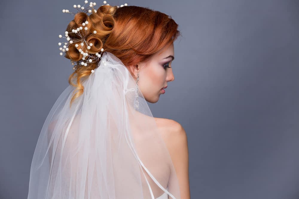 Wedding upstyle with veil - woman with red hair.