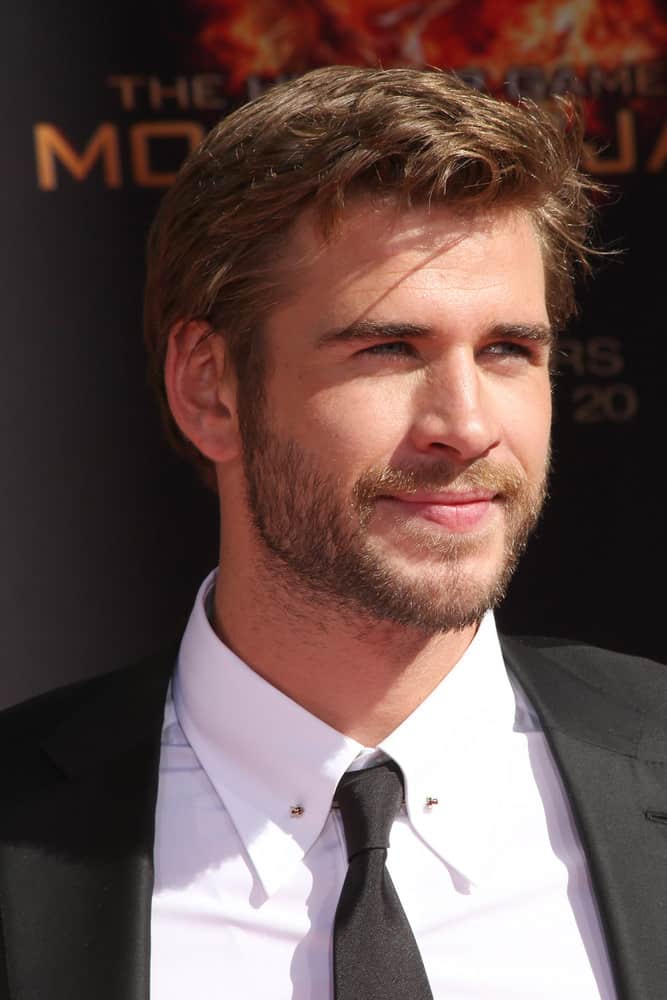 Liam Hemsworth had side-parted short hair with wavy locks at front during the Hunger Games Handprint and Footprint Ceremony at the TCL Chinese Theater, Los Angeles, CA in 2015.