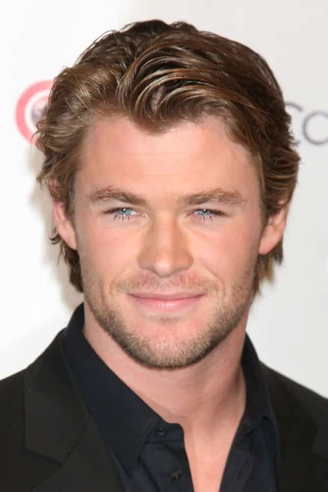 Chris Hemsworth attended the CinemaCon Convention Awards Gala Press Room in 2010 wearing his tousled side-swiped medium-length hair with a reddish brown tone.