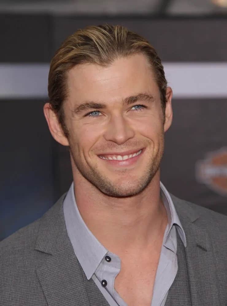 Chris Hemsworth wore a sexy man bun matched with a carefree gray detailed suit during the 2012 world premiere of The Avengers.