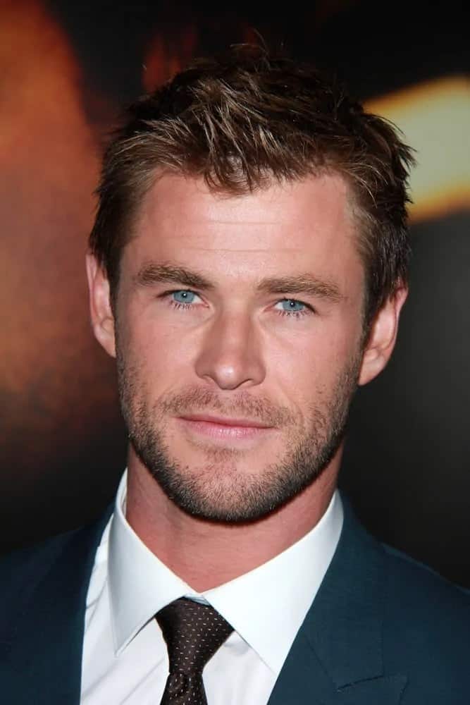 The actor paired his dark blue suit with his short spiky crew cut hair that has a dark reddish brown hue during the world premiere of Black Hat in 2014.
