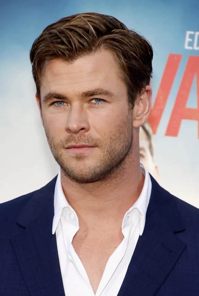 Chris Hemsworth wore his short side swept hairstyle with subtle highlights at the Los Angeles premiere of 'Vacation' in 2015. It matches well with his simple blue suit and white button shirt.