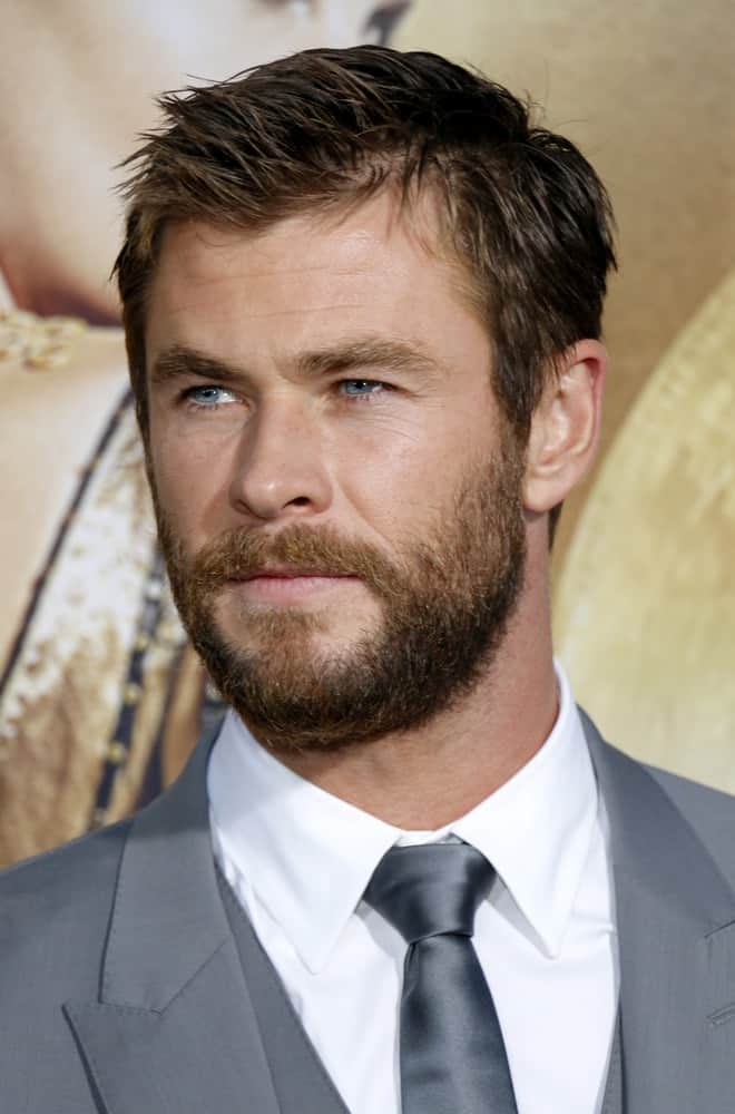Chris Hemsworth was at the April 11, 2016 US premiere of "The Huntsman: Winter's War" at the Regency Village Theatre in Westwood. He opted for a gray suit to pair with his dark brown crew cut hair and beard.