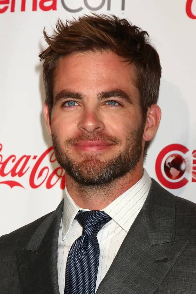 Chris Pine paired his bearded look with short tousled hair featuring some side-swept spikes during the CinemaCon Big Screen Achievement Awards at Las Vegas in 2013.