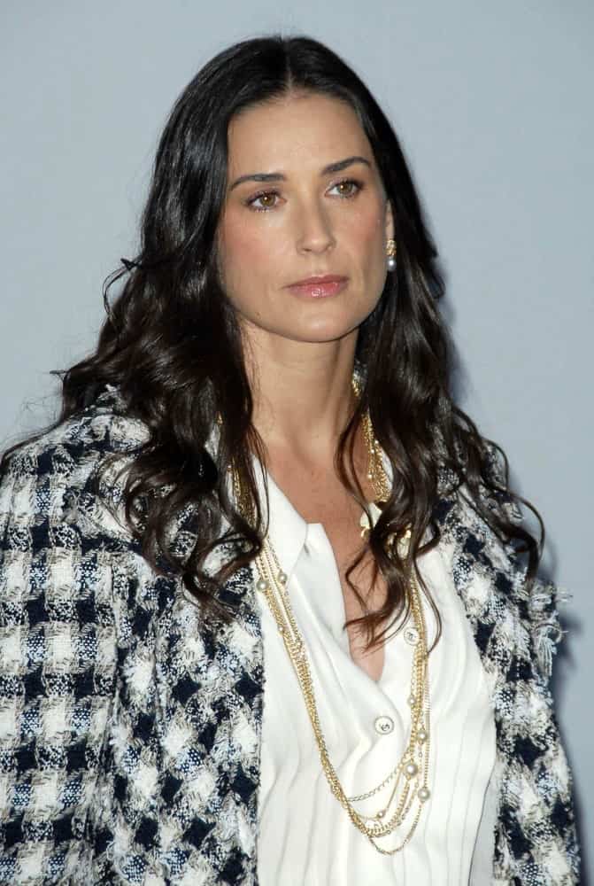 Demi Moore sported a center-parted permed hair with defined curls during the 2007/2008 Chanel Cruise Show Presented by Karl Lagerfeld last May 18, 2007. She complemented it with a classy chic outfit showcasing a white button-down topped with a plaid blazer and layered necklace.