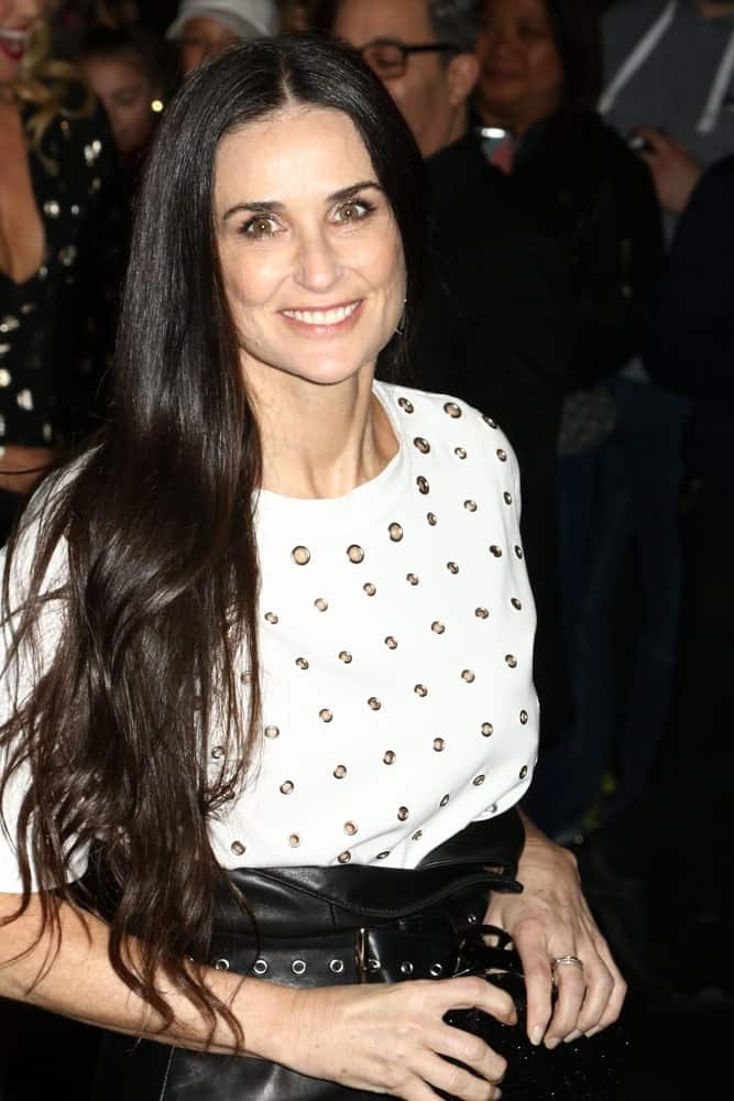 The actress is seen on April 19, 2017, in New York City flashing a sweet smile in a trendy getup along with her long black wavy hair that's tousled a bit. 