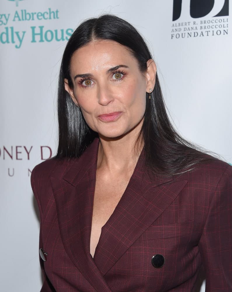 Demi Moore attended the Friendly House Lucheon on October 27, 2018, in Hollywood, CA with a classy burgundy plaid suit and a sleek black hair that's center-parted.