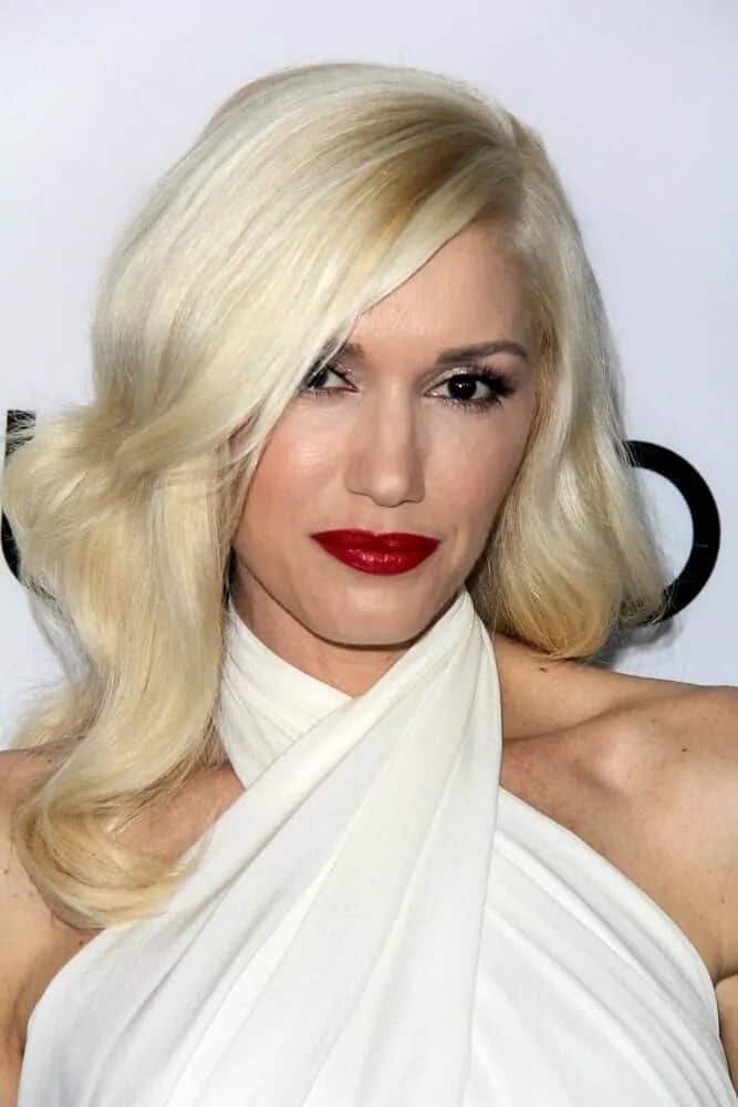 The talented singer Gwen Stefani was a vision of sophistication in her white dress at the "The Bling Ring" Los Angeles 2013 Premiere. She paired this with a classic side-swept hairstyle with tousled waves.