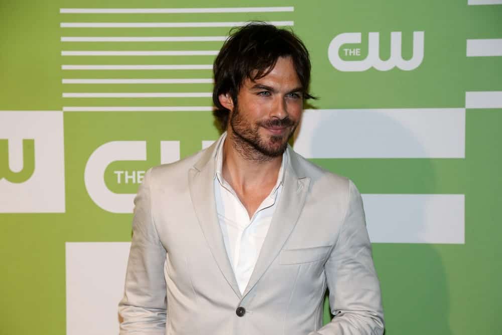 The actor attended the 2015 CW Network Upfront Presentation at the London Hotel on May 14, 2015, in a classic gray suit and a tousled hairstyle that goes perfectly with his beard.