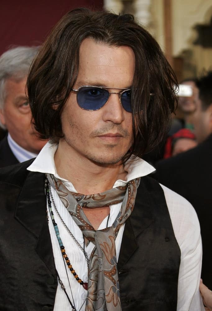 Johnny Depp attended the World Premiere of "Pirates of the Caribbean: At World's End" held at Disneyland in Anaheim last May 19, 2007. He showed up with his usual quirky and unique fashion ensemble and long wavy hair tousled for volume.