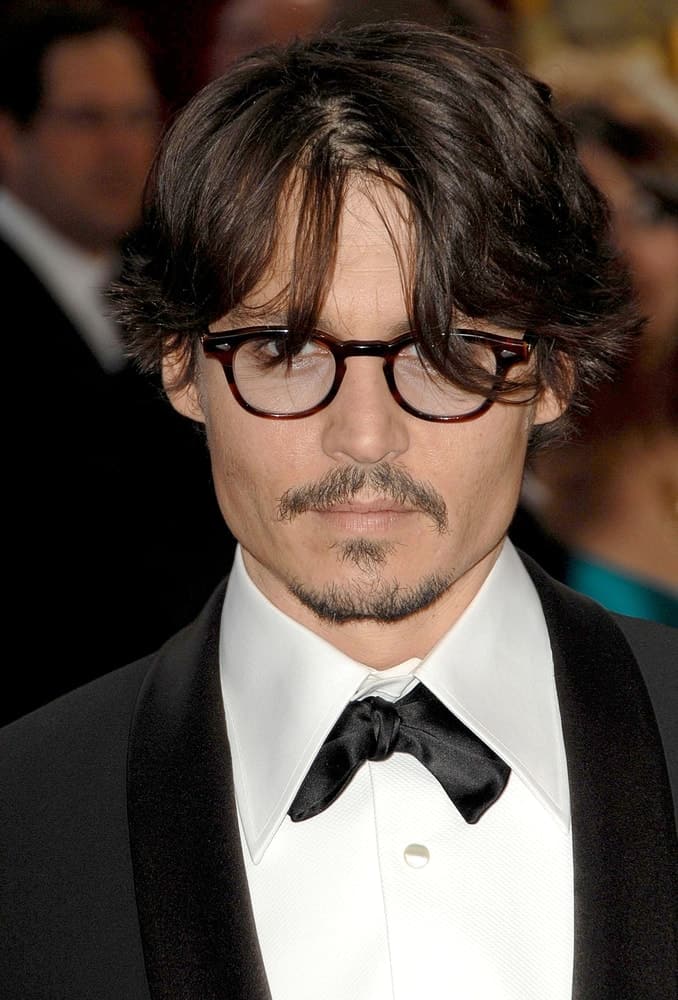 Johnny Depp was wearing a classy tuxedo with his messy and wavy hair with wispy bangs at the 80th Annual Academy Awards Oscars Ceremony, The Kodak Theatre in Los Angeles last February 24, 2008.