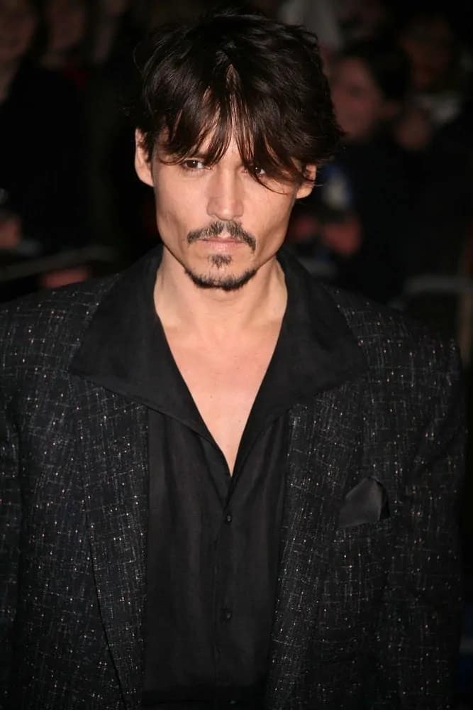 A leaner Johnny Depp looked brooding and gaunt under the veil of his dark wispy bangs when he arrived at the European Premiere of "Sweeney Todd" at the Odeon Leicester Square last January 10, 2008 in London, England.