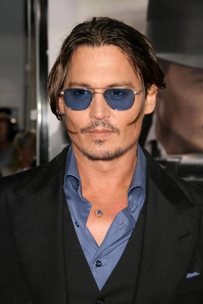 Johnny Depp tied his hair in a bun during the Los Angeles Premiere of "Public Enemies" held at Mann Village, Westwood, CA in 2009.