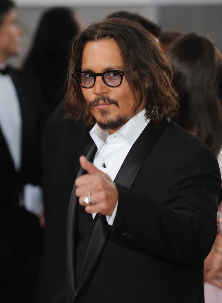 Johnny Depp had shoulder-length wavy hair with highlights at the 68th Annual Golden Globe Awards on January 16, 2011 in Beverly Hills.