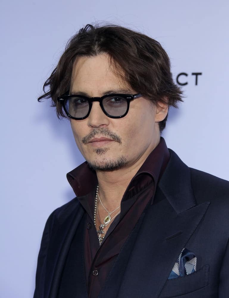 Johnny Depp arrived at the "Rum Diary" World Premiere last October 13, 2011 in Los Angeles wearing a classy three-piece suit balanced by his messy and wavy hair parted in the middle.