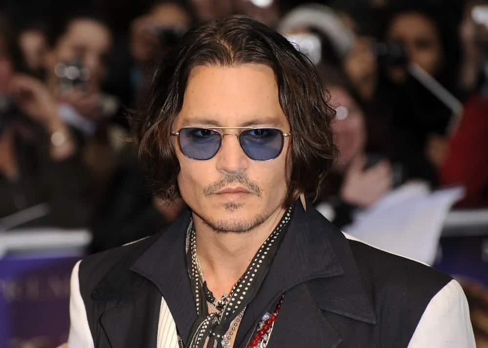 Johnny Depp exuded a rugged appeal with a stylish chin-length wavy bob hairstyle during the UK premiere of the "Dark Shadows" at the Empire Leicester square on May 9, 2012 in London.