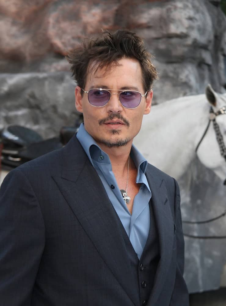 Johnny Depp and his stylish messy raven hair attended the premiere of The Lone Ranger at Odeon Leicester Square on Jul 21, 2013 in London.