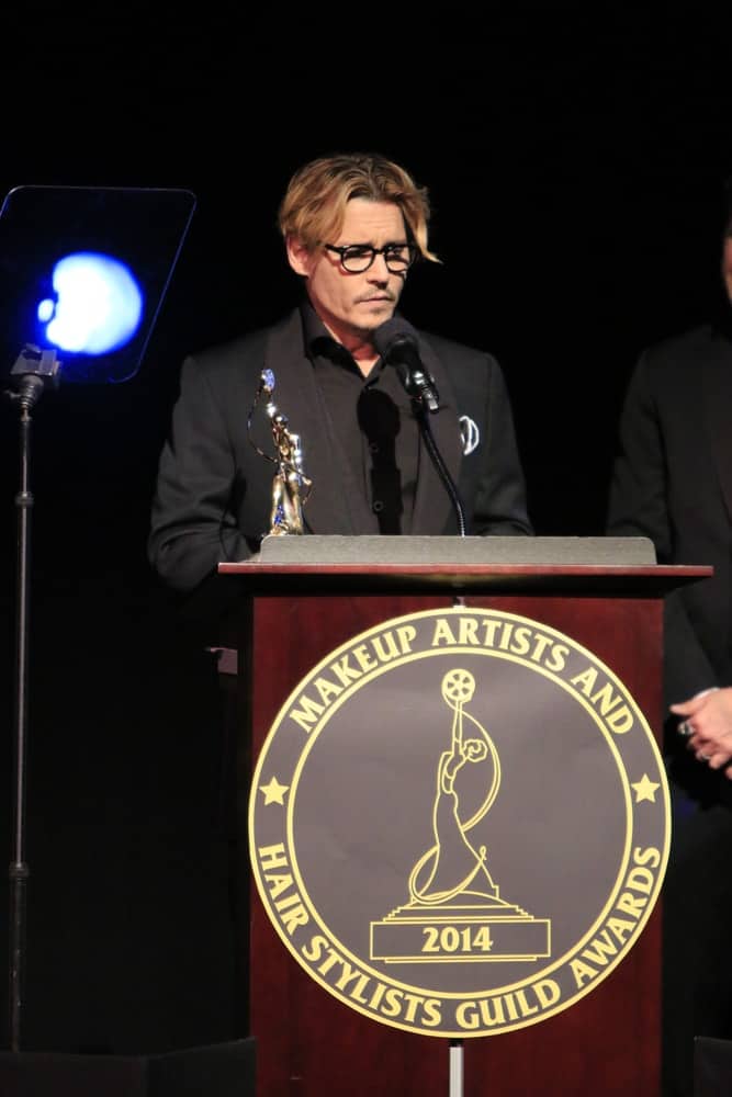Johnny Depp had a reddish brown dyed hair that is center parted at the Annual Make-Up Artists And Hair Stylists Guild Awards at Paramount Theater on February 15, 2014 in Los Angeles.