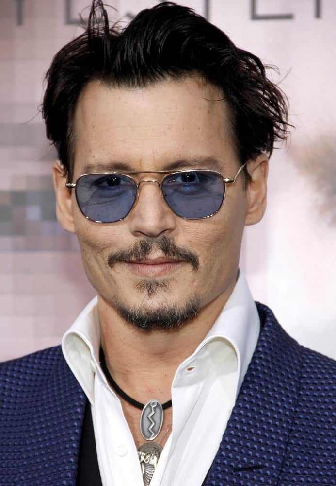 Johnny Depp was at the Los Angeles premiere of "Transcendence" held at the Regency Village Theatre in Westwood on April 10, 2014 in Los Angeles, California. He wore his blue detailed suit to match his colored sunglasses that complements his tossed slick hair.