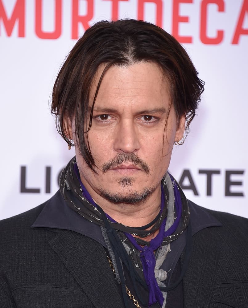 Johnny Depp was seen at the "Mortdecai" Los Angeles Premiere last January 21, 2015 in Hollywood. He wore his signature unique fashion with his long undercut hairstyle with subtle highlights.