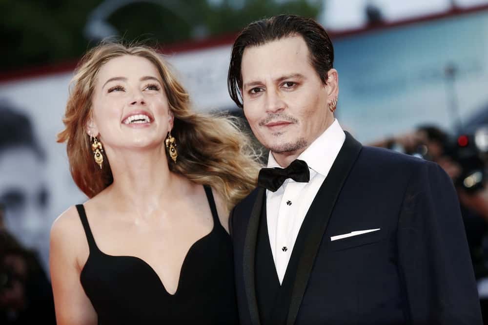 Johnny Depp and Amber Heard attended the September 4, 2015 'Black Mass' premiere in Venice, Italy. Depp went for a elegant and classic look with his long hair slicked neatly and five o'clock shadow.