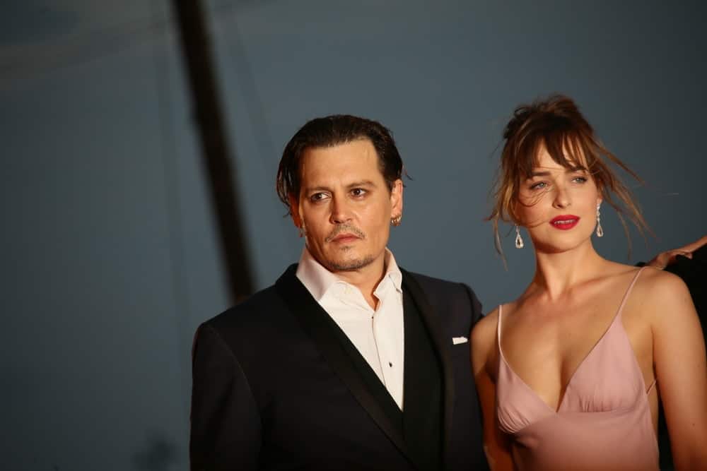 Johnny Depp and Dakota Johnson attended the premiere of the movie 'BLACK MASS' during the 72nd Venice Film Festival last September 4, 2015 in Venice, Italy. He opted for a vintage slicked back hairstyle to his long raven hair.