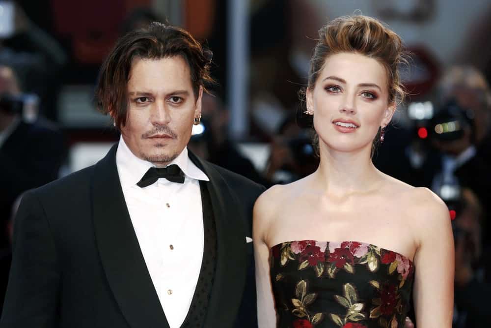 Johnny Depp and Amber Heard attend the premiere of 'THE DANISH GIRL' during the 72nd Venice Film Festival last September 5, 2015 in Venice, Italy. He looked dapper in his black suit that complements his reddish brown hair that was slightly tousled and highlighted.