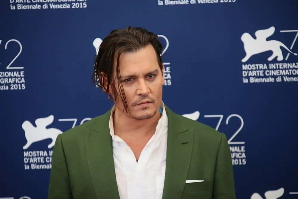 Johnny Depp was confident with his medium-length tousled slicked back hairstyle and some facial hair at the "Black Mass" photocall during the 72nd Venice Film Festival last September 4, 2015 in Venice, Italy.