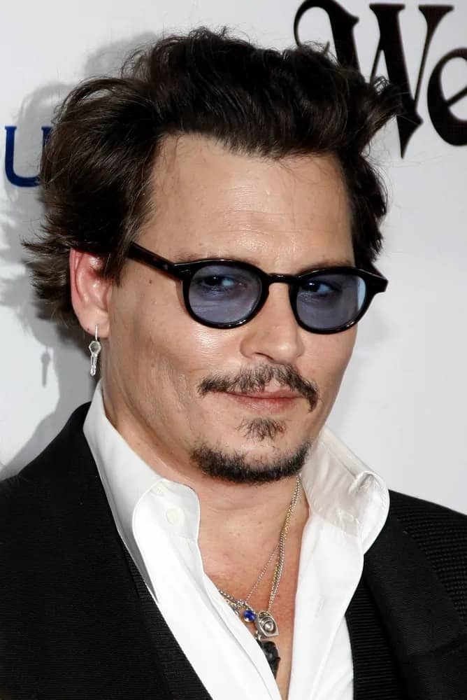 Johnny Depp opted for a tousled brushed up flippy hairstyle that goes quite well with hisblack suit when he attended the Art Of Elysium's 9th Annual Heaven Gala held at the 3LABS in Culver City last January 9, 2016.