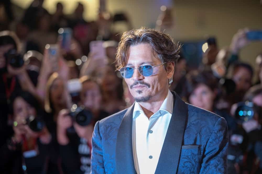 Johnny Depp was at the ''Waiting For The Barbarians'' screening during the 76th Venice Film Festival at Sala Grande last September 06, 2019 in Venice, Italy. His elegant detailed blue suit goes well with his reddish brown tousled and flipped hair.