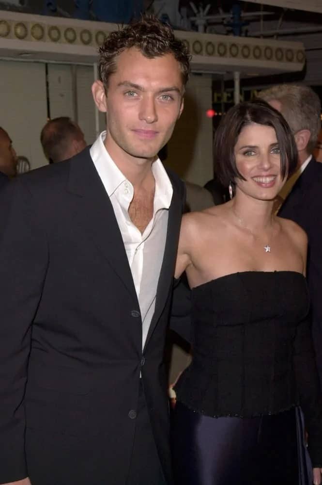 A young Jude Law sported a short curly hairstyle when he posed with his then girlfriend, actress Sadie Frost, at the Los Angeles premiere of his movie "The Talented Mr. Ripley" in 1999.