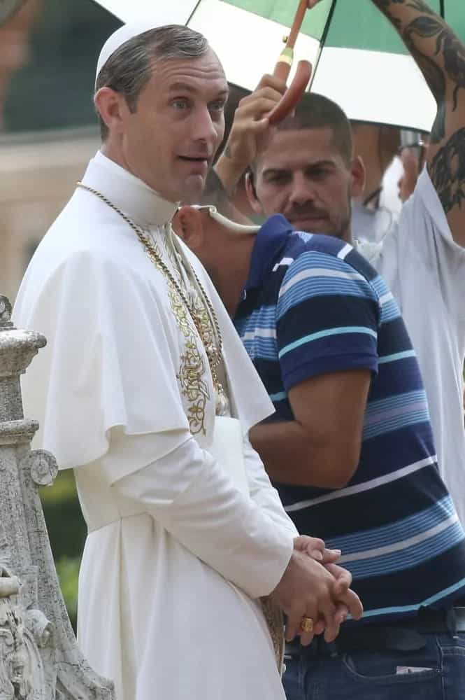 Jude Law pulled off the salt and pepper hair color with a side-parted style while filming some scenes for the movie "The Young Pope" in the gardens of Villa Pamphili in 2015.
