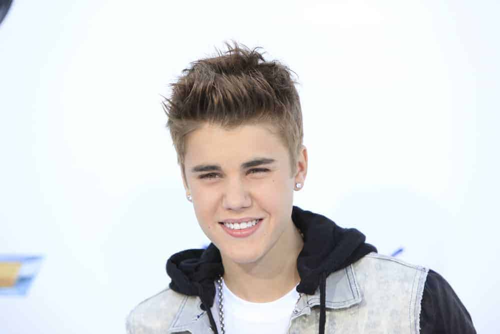 Justin Bieber wore a spiked up hairstyle during the 2012 Billboard Music Awards held at the MGM Grand Garden Arena, Las Vegas, NV. He paired it with stud earrings and a bling.