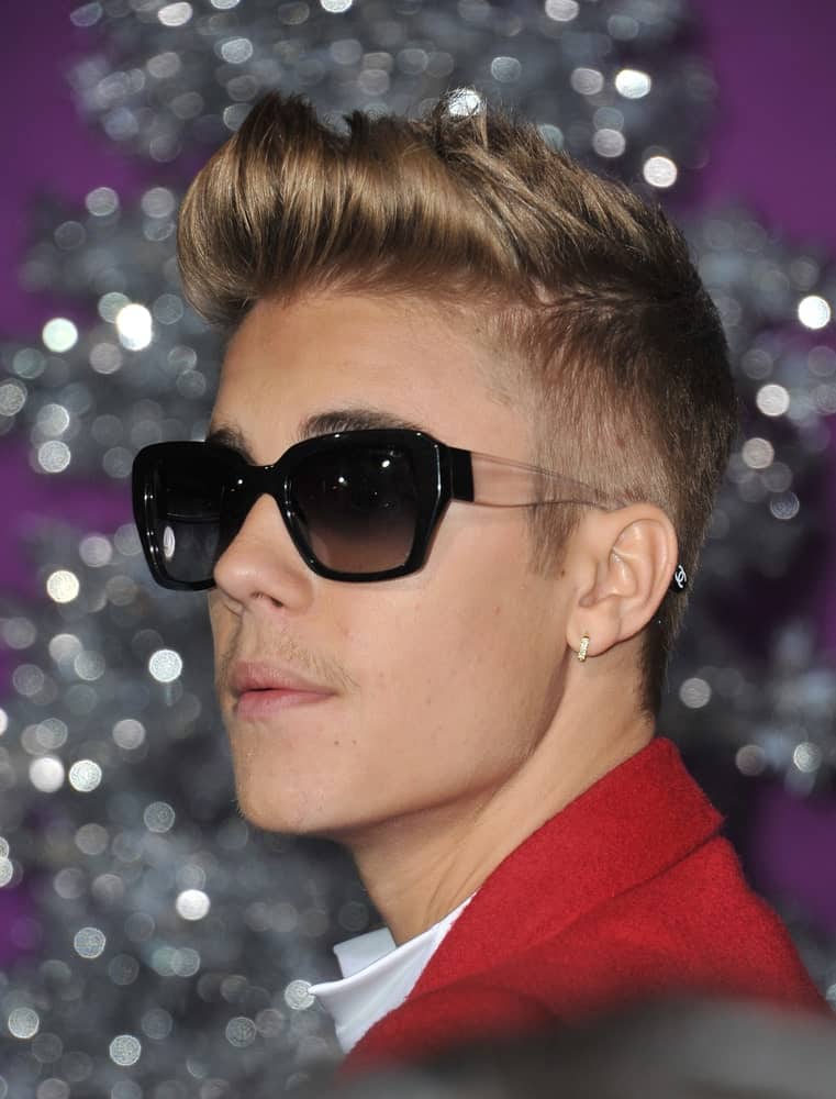 The singer exhibited a brushed up crew cut during the world premiere of his movie "Justin Bieber's Believe" last December 18, 2013. He finished the look with black shades and a vibrant red suit.