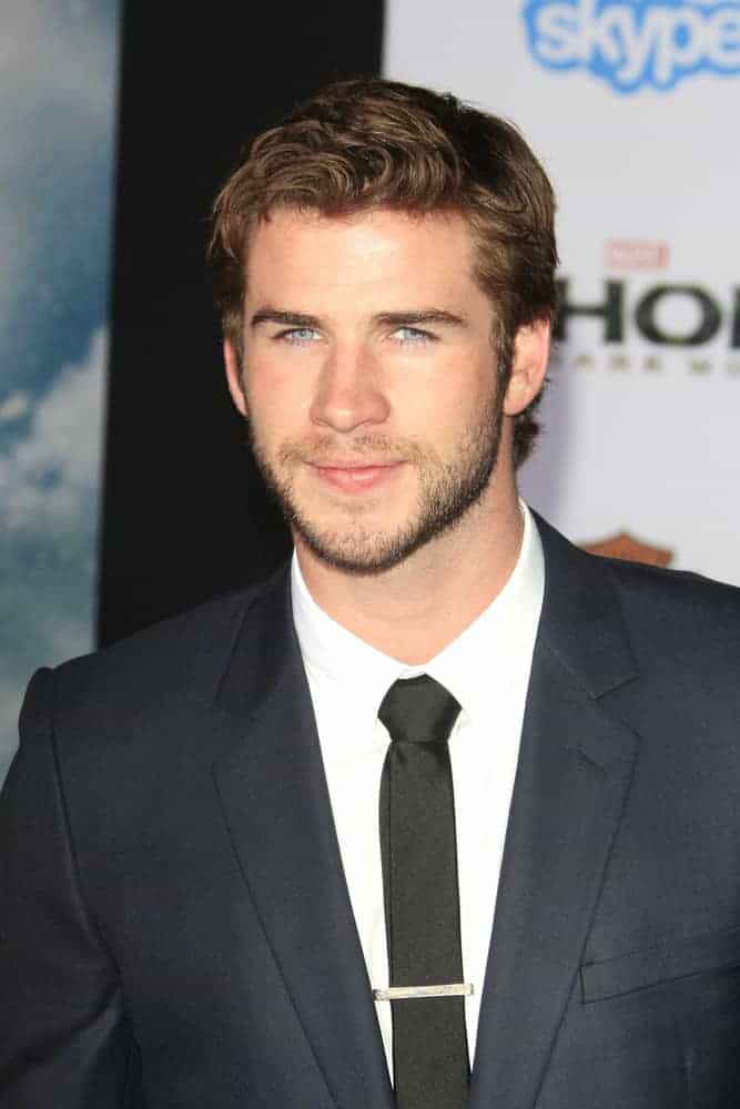 Liam Hemsworth had short hair with wavy bangs when he attended the premiere of "Thor: The Dark World" at El Capitan Theater, Los Angeles, CA in 2013.