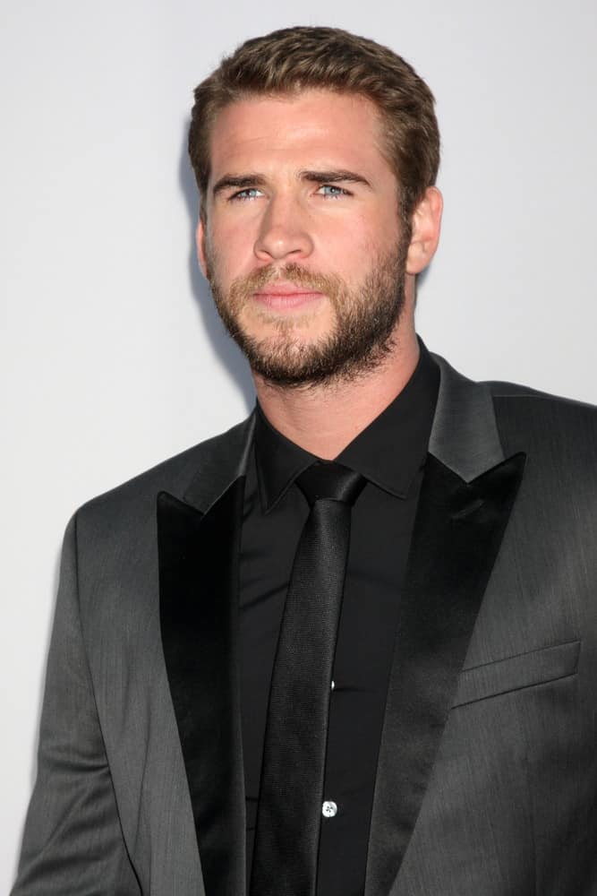 Liam Hemsworth attended the Los Angeles premiere of "Paranoia" in 2013 with mega short side parted hair.
