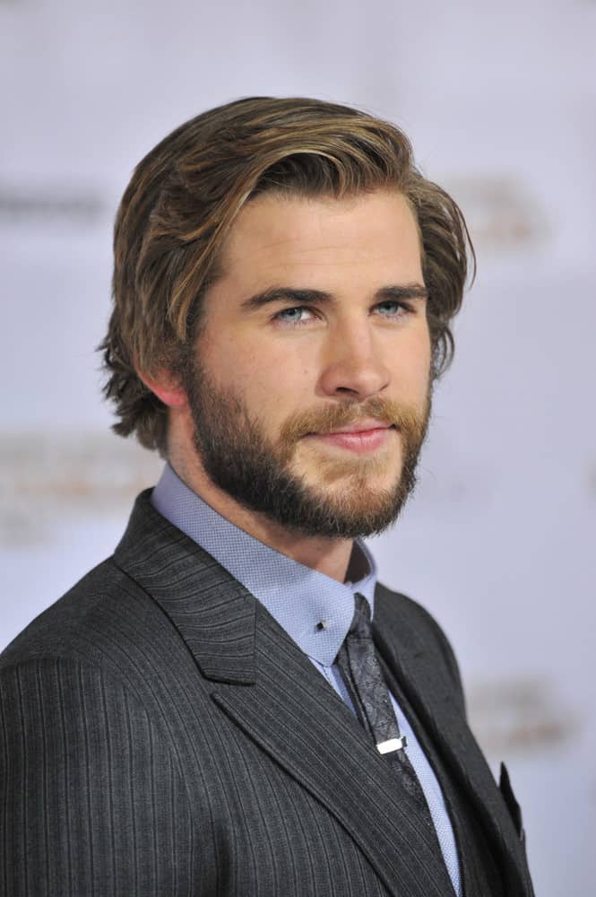 Liam Hemsworth looked manly with a full beard and medium-length layered hairstyle during the photocall of the 66th Cannes Film Festival for "The Hunger Games: Catching Fire" in 2013.