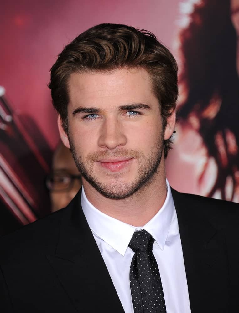 The actor is a head-turner in a black suit and pompadour hairstyle during the "The Hunger Games: Catching Fire" Los Angeles Premiere on November 18, 2013.