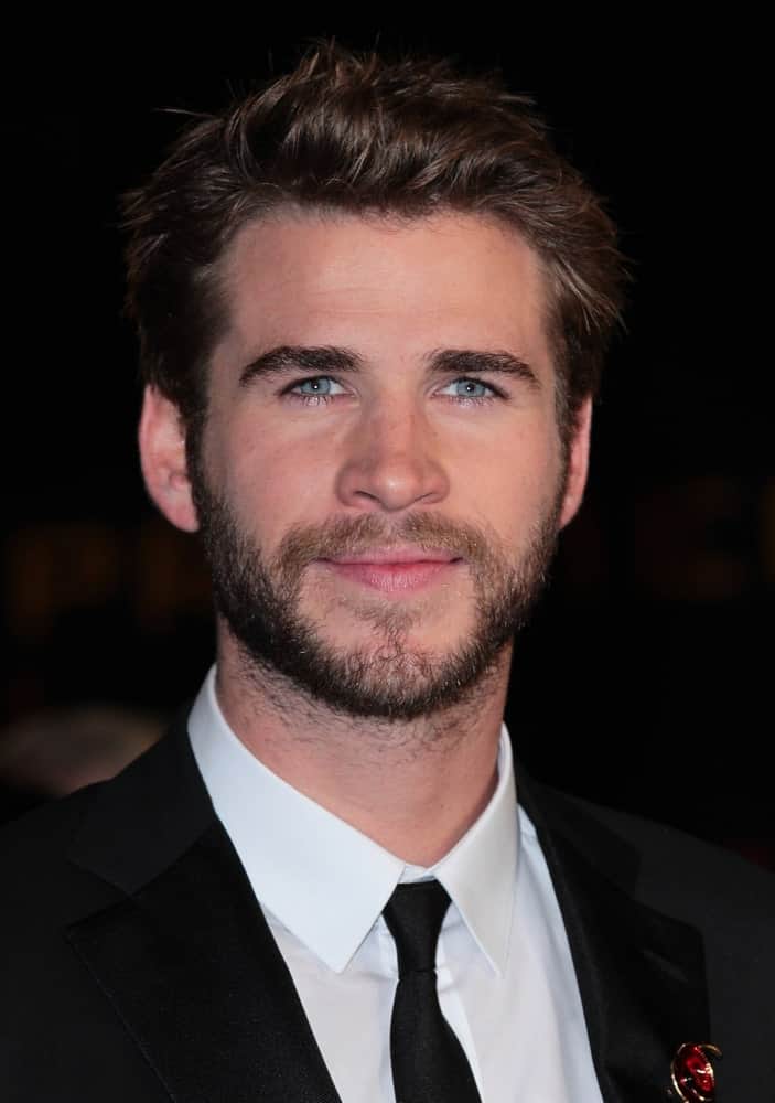Actor Liam Hemsworth stands out at the Hunger Games: Mockingjay - Part 2 - UK film premiere on Nov 5, 2015, exhibiting his brunette hair with highlights.