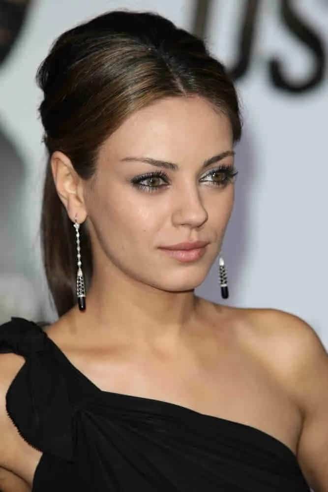 Mila Kunis was stunning in her goddess-like black dress that she wore with her slightly tousled ponytail and smoky eyes at The Book of Eli premiere last January 11 2010.