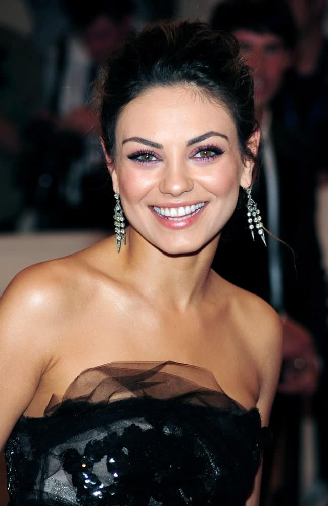 Mila Kunis was positively glowing in her detailed dark dress and messy upstyle hairdo that brings focus on her earrings and neckline. She wore this look at The Metropolitan Museum of Art in New York, May 3, 2010.