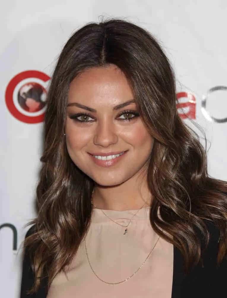 Mila Kunis was effortlessly stunning with her bright eyes and subtle highlights on her loose curls with a center part during the Cinema Con 2012-Disney Luncheon last April 25, 2012.